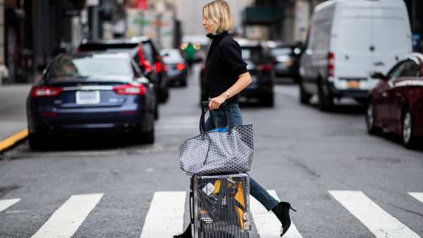 NEW YORK, NY - SEPTEMBER 12: Lisa Hahnbueck wearing velvet Roger Vivier boots, Re/done Levis jeans, Self Portrait turtleneck, Goya bag, Rimowa x Off White travel bag, trolley, suitcase is seen during New York Fashion Week Spring/Summer 2019 on September 12, 2018 in New York City. (Photo by Christian Vierig/Getty Images)