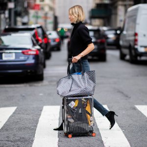 NEW YORK, NY - SEPTEMBER 12: Lisa Hahnbueck wearing velvet Roger Vivier boots, Re/done Levis jeans, Self Portrait turtleneck, Goya bag, Rimowa x Off White travel bag, trolley, suitcase is seen during New York Fashion Week Spring/Summer 2019 on September 12, 2018 in New York City. (Photo by Christian Vierig/Getty Images)