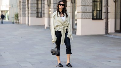 BERLIN, GERMANY - MARCH 23: Aylin Sengül wears black capri cropped pants Massimo Dutti, beige belted oversized trench jacket the Frankie Shop, black loafers & bag Chanel, sunglasses Phoebe Philo on March 23, 2026 in Berlin, Germany. (Photo by Christian Vierig/Getty Images)
