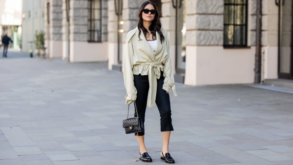 BERLIN, GERMANY - MARCH 23: Aylin Sengül wears black capri cropped pants Massimo Dutti, beige belted oversized trench jacket the Frankie Shop, black loafers & bag Chanel, sunglasses Phoebe Philo on March 23, 2026 in Berlin, Germany. (Photo by Christian Vierig/Getty Images)