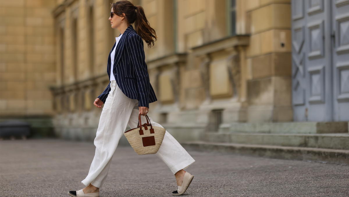 Cleo zu Oettingen-Spielberg wearing navy blue striped Polo Ralph Lauren jacket, white polo and white linen pants and beige Loewe bag via Lodenfrey SS21 on May 10, 2021 in Munich, Germany.