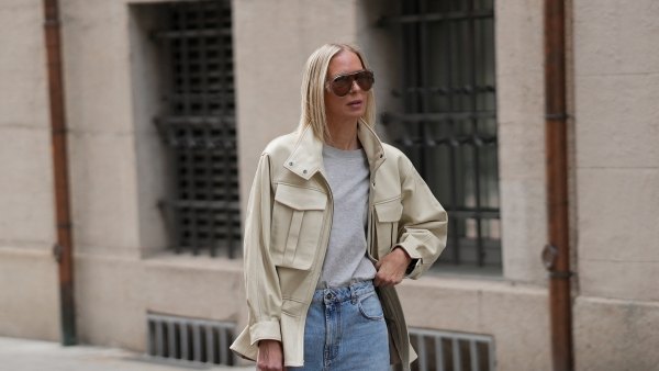 MUNICH, GERMANY - APRIL 29: Mirja Klein is seen wearing an off-white "Hope" leather jacket with a high funnel collar, zip front closure, large chest patch pockets and a peplum hem from Ducie London; a gray crew neck t-shirt from COS; light blue wide-leg denim jeans from Rohe; off-white leather kitten heel pumps from Massimo Dutti; a dark olive perforated suede "Midi Stockholm" top handle bag with gold tone hardware from DeMellier; a nude nail polish manicure; oversized "Scudo Shield" sunglasses with brown tinted lenses from Bottega Veneta; her blonde straight hair is worn loose; with a natural make-up on April 29, 2026 in Munich, Germany. (Photo by Moritz Scholz/Getty Images)