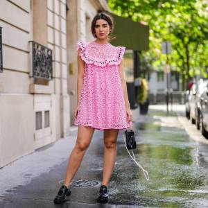 PARIS, FRANCE - MAY 05: Ketevan Giorgadze @katie.one wears a pink babydoll sleeveless mini dress with embroidery "broderie anglaise" from Manoush, a black leather pearl bag from LPA, classic masculine leather loafers shoes from Prada, pearl pony cuff from Lelet NY, on May 05, 2021 in Paris, France. (Photo by Edward Berthelot/Getty Images)