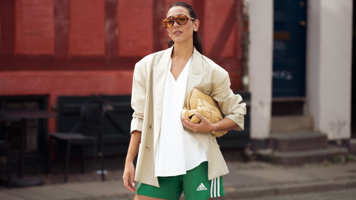 COPENHAGEN, DENMARK - AUGUST 05: Ambre Lipuma wears green Adidas shorts, white top, beige blazer, beige bag and sunglasses outside Tekla breakfast during Copenhagen Fashion Week day two on August 05, 2025 in Copenhagen, Denmark. (Photo by Raimonda Kulikauskiene/Getty Images)