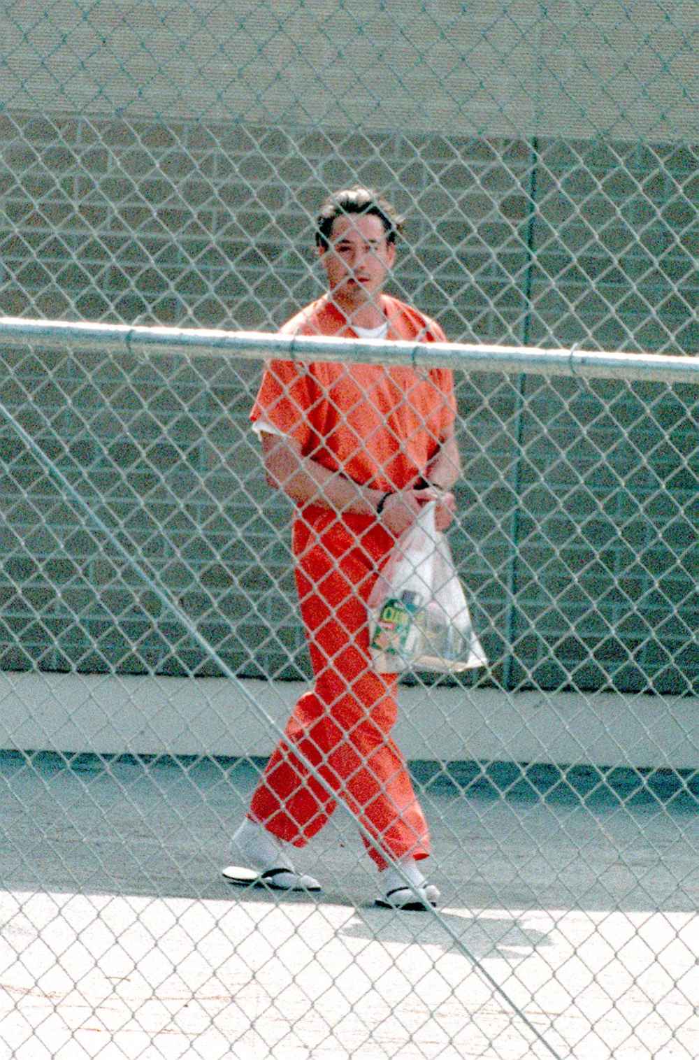 Robert Downey Jr. walking outside prison in his jumpsuit.