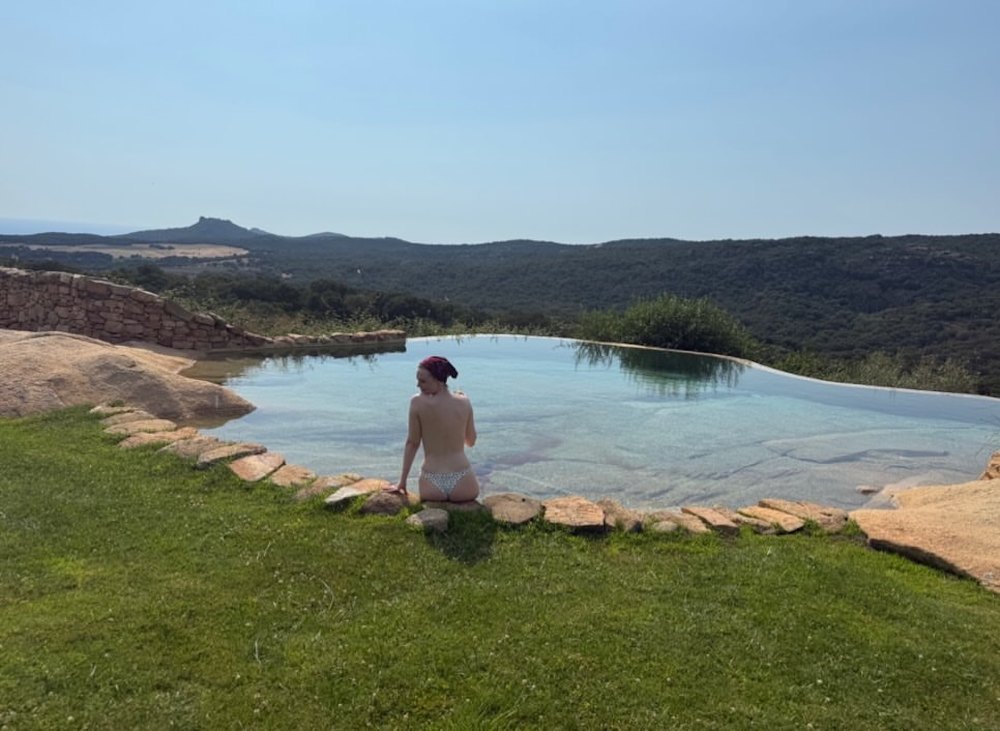 Elle Fanning Poses Topless in Cheeky Bottoms on Vacation