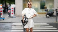 FRANKFURT AM MAIN, GERMANY - JUNE 3: Laura Wittek is seen wearing a white cotton oversized cropped jacket with a high collar, button front closure and gathered sleeves from Laura Wittek x Na-kd; white cotton shorts with a straight silhouette and elastic waist detail from Massimo Dutti; a black leather compact shoulder bag with a curved silhouette and silver tone hardware from Balenciaga; silver bracelets and rings; rectangular acetate sunglasses with dark tinted lenses from Corlin Eyewear; silver Apple headphones; her blonde hair is worn in a sleek bob with a center part; with natural make up on June 3, 2026 in Frankfurt am Main, Germany. (Photo by Moritz Scholz/Getty Images)