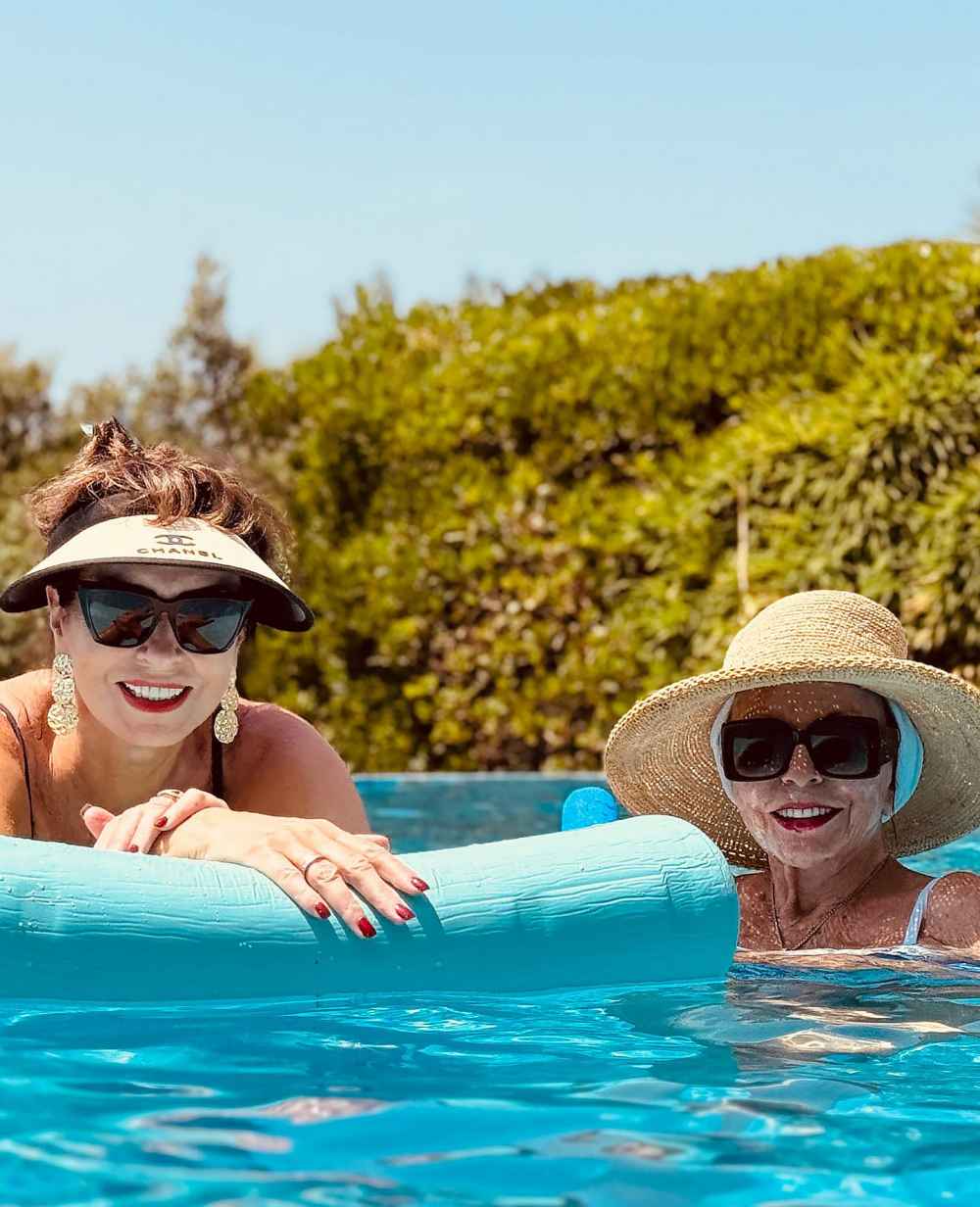Joan Collins Serves Timeless Glamour in Swimsuit and White Dress With Ex Bond Girl 3