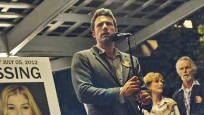 Rosamund Pike (in poster), Ben Affleck, Lisa Banes, David Clennon in Gone Girl