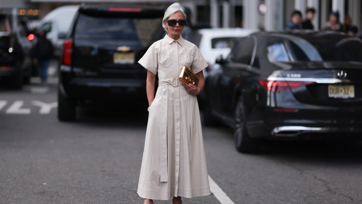 NEW YORK, NEW YORK - FEBRUARY 13: Grece Ghanem seen wearing a long white blouse dress, a golden Carolina Herrera bag, Gucci pink heels and dark shades before the Carolina Herrera show on February 13, 2023 in New York City. (Photo by Jeremy Moeller/Getty Images)