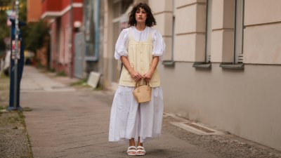 BERLIN, GERMANY - AUGUST 18: Lea Naumann wearing white Cecilie Bahnsen long dress, yellow Chanel vintage top, white Birkenstock sandals and Taillee mini bag on August 18, 2021 in Berlin, Germany. (Photo by Jeremy Moeller/Getty Images)