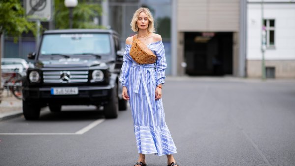 BERLIN, GERMANY - JULY 06: Lisa Hahnbueck wearing striped off shoulder dress Mykke Hofmann, MCM Stark fanny belt bag, Hermes Oran sandals seen during the Berlin Fashion Week July 2018 on July 6, 2018 in Berlin, Germany. (Photo by Christian Vierig/Getty Images)