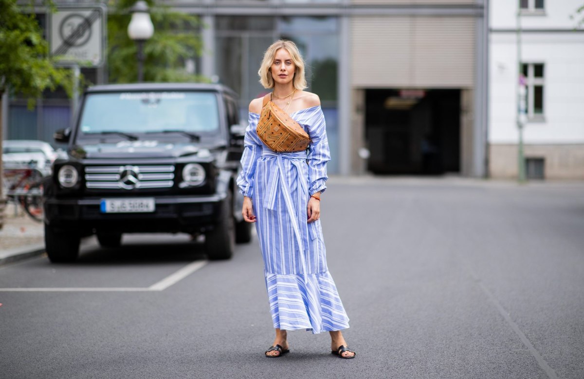 BERLIN, GERMANY - JULY 06: Lisa Hahnbueck wearing striped off shoulder dress Mykke Hofmann, MCM Stark fanny belt bag, Hermes Oran sandals seen during the Berlin Fashion Week July 2018 on July 6, 2018 in Berlin, Germany. (Photo by Christian Vierig/Getty Images)