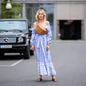 BERLIN, GERMANY - JULY 06: Lisa Hahnbueck wearing striped off shoulder dress Mykke Hofmann, MCM Stark fanny belt bag, Hermes Oran sandals seen during the Berlin Fashion Week July 2018 on July 6, 2018 in Berlin, Germany. (Photo by Christian Vierig/Getty Images)