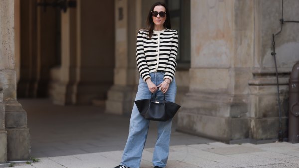 HAMBURG, GERMANY - MAY 09: Elise Seitz seen wearing Bottega Veneta black shades, Celine black belt, Adidas black samba sneaker, Agolde blue jeans, Massimo Dutti striped black and white cardigan and Demellier black bag on May 09, 2023 in Hamburg, Germany. (Photo by Jeremy Moeller/Getty Images)