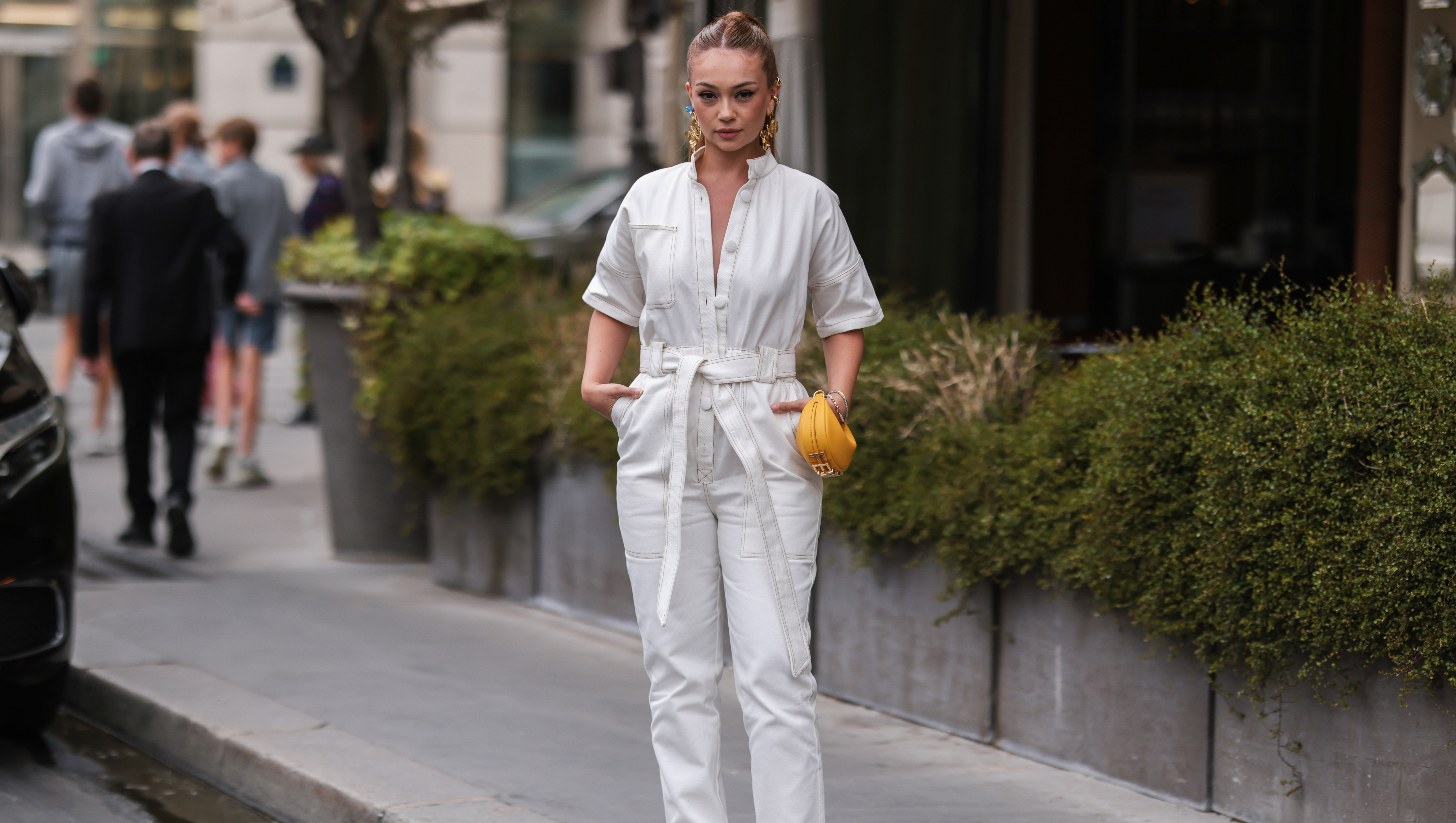 PARIS, FRANCE - JULY 07: A guest is seen wearing white overall, yellow small Fendi bag, golden earrings outside outside Fendi, during Paris Fashion Week - Haute Couture Fall Winter 2022 2023, on July 07, 2022 in Paris, France. (Photo by Jeremy Moeller/Getty Images)