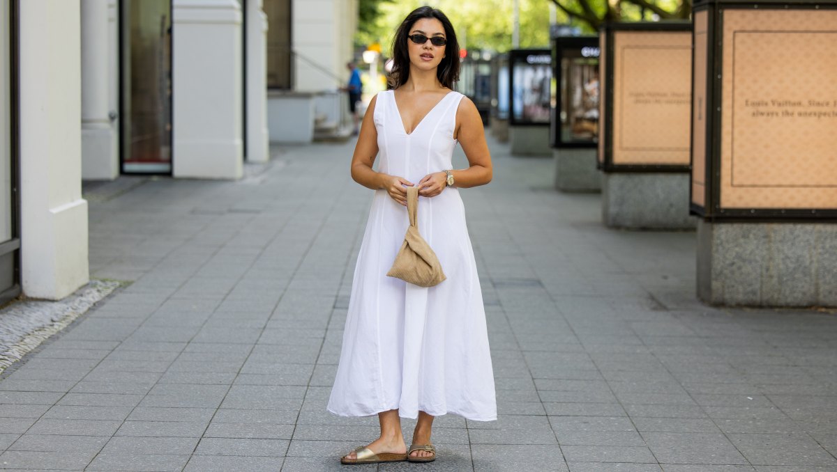 BERLIN, GERMANY - JULY 02: Bella Emar wears Massimo Dutti white dress, beige Byrein bag, Birkenstock Shoes, Le specs Sunnies, Rolex Datejust watch during the Berlin Fashion Week Spring/Summer 2026 at on July 02, 2026 in Berlin, Germany. (Photo by Christian Vierig/Getty Images)