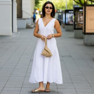BERLIN, GERMANY - JULY 02: Bella Emar wears Massimo Dutti white dress, beige Byrein bag, Birkenstock Shoes, Le specs Sunnies, Rolex Datejust watch during the Berlin Fashion Week Spring/Summer 2026 at on July 02, 2026 in Berlin, Germany. (Photo by Christian Vierig/Getty Images)