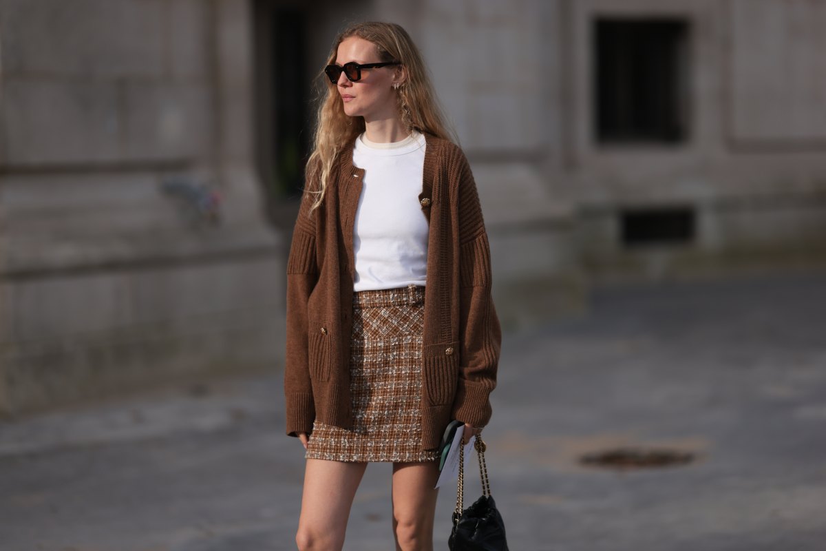 PARIS, FRANCE - OCTOBER 01: Marie von Behrens is seen wearing a brown plaid skirt, with a white top, a long brown cardigan, with a black Chanel handbag and black-brown sunglasses during the Chanel Show Womenswear Spring/Summer 2025 as part of Paris Fashion Week on October 01, 2024 in Paris, France. (Photo by Jeremy Moeller/Getty Images)