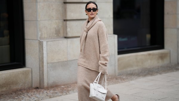 Laura Noltemeyer is seen wearing an oversized beige alpaca wool sweater with tie-back detailing by Aylin König; a long alpaca wool knit skirt in a straight cut by Aylin König; an alpaca knit scarf draped and knotted around the neck by Aylin König; a white intrecciato leather handbag called „Arco Bag“ by Bottega Veneta; slim black cat-eye sunglasses by Yves Saint Laurent; gold statement earrings with a green stone detail by Mango; her brown and straight hair is tied in a low ponytail on October 16, 2025 in Hamburg, Germany.