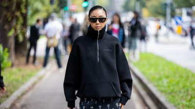 MILAN, ITALY - SEPTEMBER 20: Yuwei Zhangzou wears black zipper, skirt, burgundy bag outside Gucci during the Milan Fashion Week Menswear Spring/Summer 2025 on September 20, 2024 in Milan, Italy. (Photo by Christian Vierig/Getty Images)