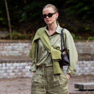 OSLO, NORWAY - SEPTEMBER 01: Andrea Steen wears green khaki wide leg shorts, blouse, knit, brown bag, sunglasses during Oslo Runway Fashion Week on September 01, 2026 in Oslo, Norway. (Photo by Christian Vierig/Getty Images)