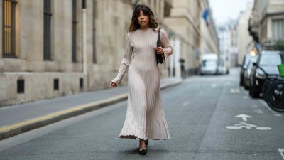 PARIS, FRANCE - NOVEMBER 07: Ellie Delphine wears a beige stripped long dress, a black leather bag, black leather ballerinas shoes, during a street style fashion photo session, on November 07, 2024 in Paris, France. (Photo by Edward Berthelot/Getty Images)