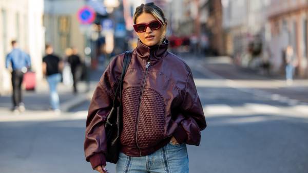 OSLO, NORWAY - SEPTEMBER 02: Isabelle Eberdean wears oversized burgundy zipper jacket, red framed sunglasses, two tone denim jeans light washed, black bag during Oslo Fashion Week on September 02, 2026 in Oslo, Norway. (Photo by Christian Vierig/Getty Images)