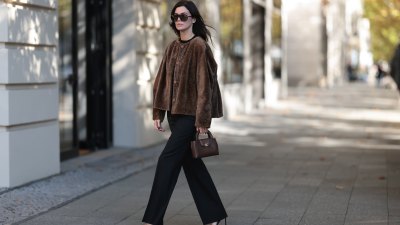 BERLIN, GERMANY - OCTOBER 5: Leo Eberlin, Tom Ford oversized black sunglasses with dark lenses, Manzoni 24 chocolate brown fur coat with a relaxed boxy silhouette and tone-deaf button-up, Zara fitted black crew-neck top, Leo Mathild diamond jewelry including stud earrings and statement rings, Audemars Piguet yellow gold watch, Chanel structured brown leather top handle bag with gold-tone CC hardware, Sézane black custom flared trousers with a clean, high-waisted silhouette, Tom Ford black patent leather heels, on October 5, 2026 in Berlin, Germany. (Photo: Jeremy Moeller/Getty Images)