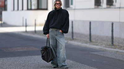 BERLIN, GERMANY - SEPTEMBER 23: Sophia Geiss seen wearing Prada oversized black aviator shades, Zara black oversized high-neck jacket layered over a black top, The Frankie Shop faded blue wide-leg jeans, COS oversized black leather tote bag, Calvin Klein black pointed-toe shoes on September 23, 2026 in Berlin, Germany. (Photo by Jeremy Moeller/Getty Images)