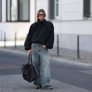 BERLIN, GERMANY - SEPTEMBER 23: Sophia Geiss seen wearing Prada oversized black aviator shades, Zara black oversized high-neck jacket layered over a black top, The Frankie Shop faded blue wide-leg jeans, COS oversized black leather tote bag, Calvin Klein black pointed-toe shoes on September 23, 2026 in Berlin, Germany. (Photo by Jeremy Moeller/Getty Images)