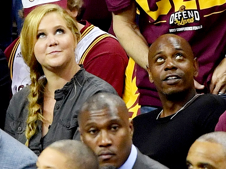 Amy Schumer and Dave Chappelle attend Game Three of the 2017 NBA Eastern Conference Finals between the Cleveland Cavaliers and the Boston Celtics at Quicken Loans Arena on May 21, 2017 in Cleveland, Ohio.