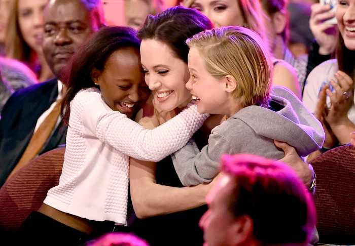 Angelina Jolie hugs Zahara Marley Jolie-Pitt (L) and Shiloh Nouvel Jolie-Pitt (R) after winning award for Favorite Villain in 'Maleficent' during Nickelodeon's 28th Annual Kids' Choice Awards held at The Forum on March 28, 2015 in Inglewood, California.