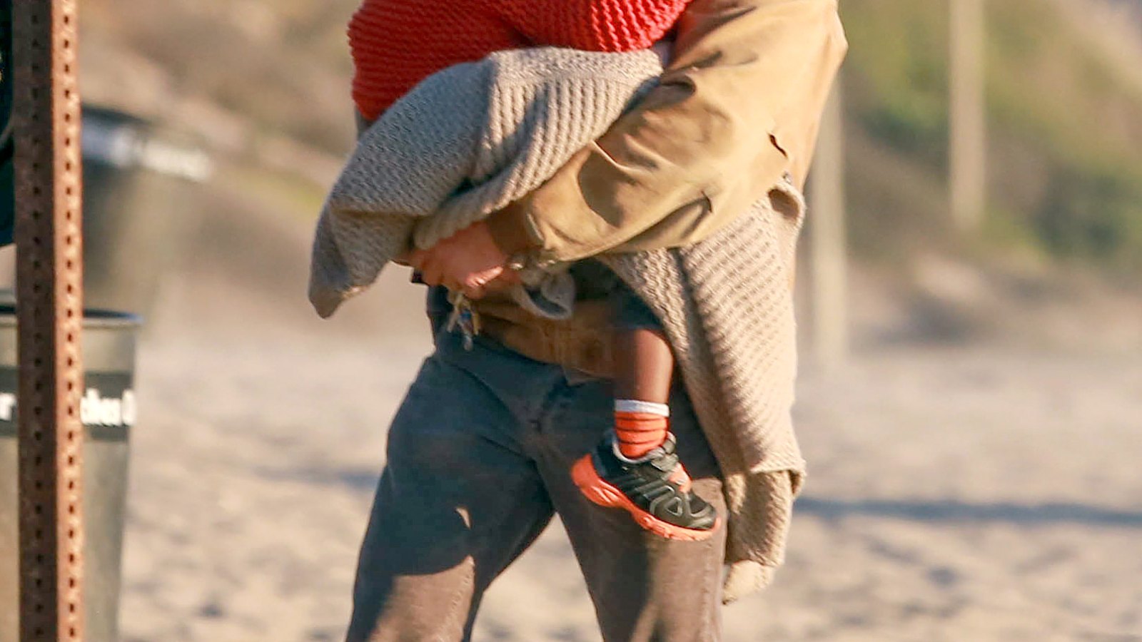 Sean Penn holds Jackson while walking on the beach Feb. 1, 2014