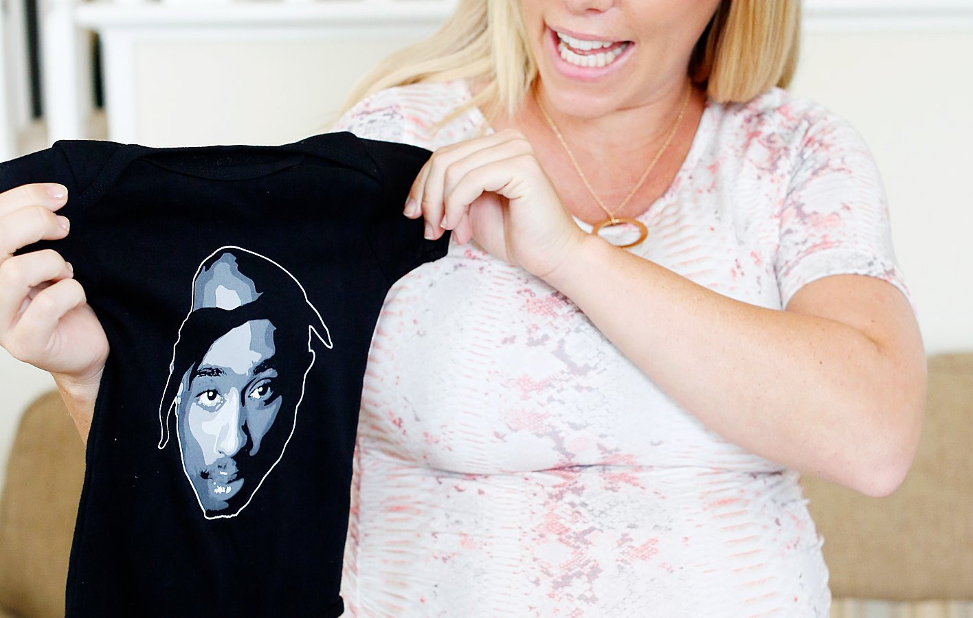 Kendra Wilkinson receives a onesie with Tupac on it at her baby shower