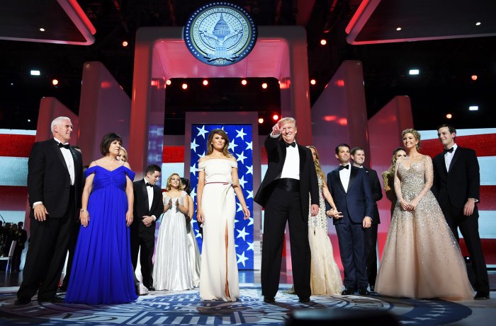 US President Donald Trump gestures as the first lady Melania Trump, Vice Presidant Mike Pence, his wife Karen and family look on at the Liberty Ball at the Washington DC Convention Center following Donald Trump's inauguration as the 45th President of the United States, in Washington, DC, on January 20, 2017.