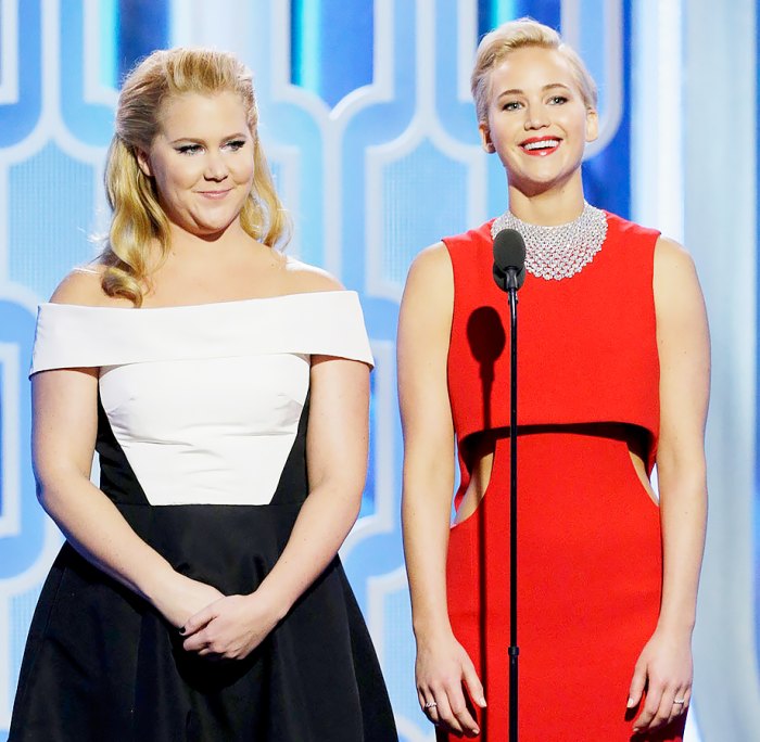 Amy Schumer and Jennifer Lawrence speak onstage during the 73rd Annual Golden Globe Awards.