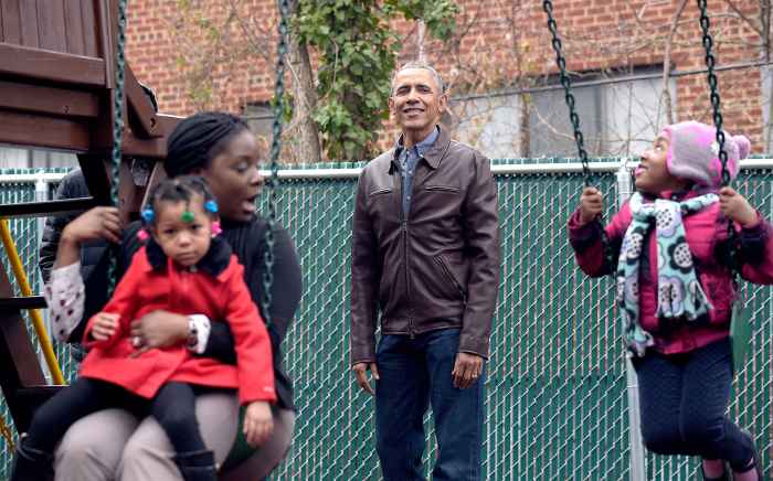 President Barack Obama watches as children play on the