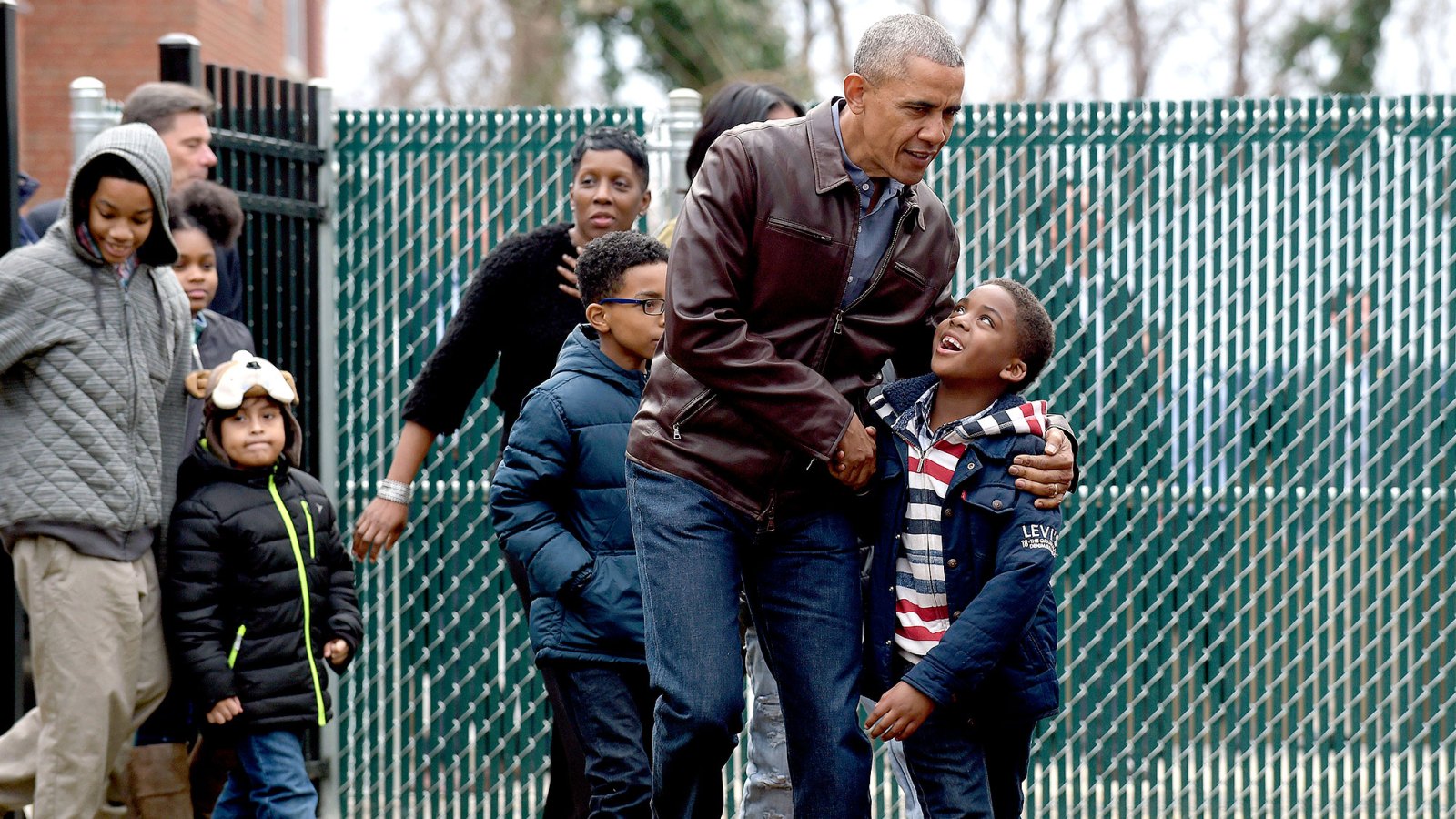 President Barack Obama talks with kids as he visits with them as they play on the "Malia and Sasha's Castle," the playground that the Obamas donated to the Jobs Have Priority Naylor Road Family Shelter in Washington, Monday, Jan. 16, 2017.
