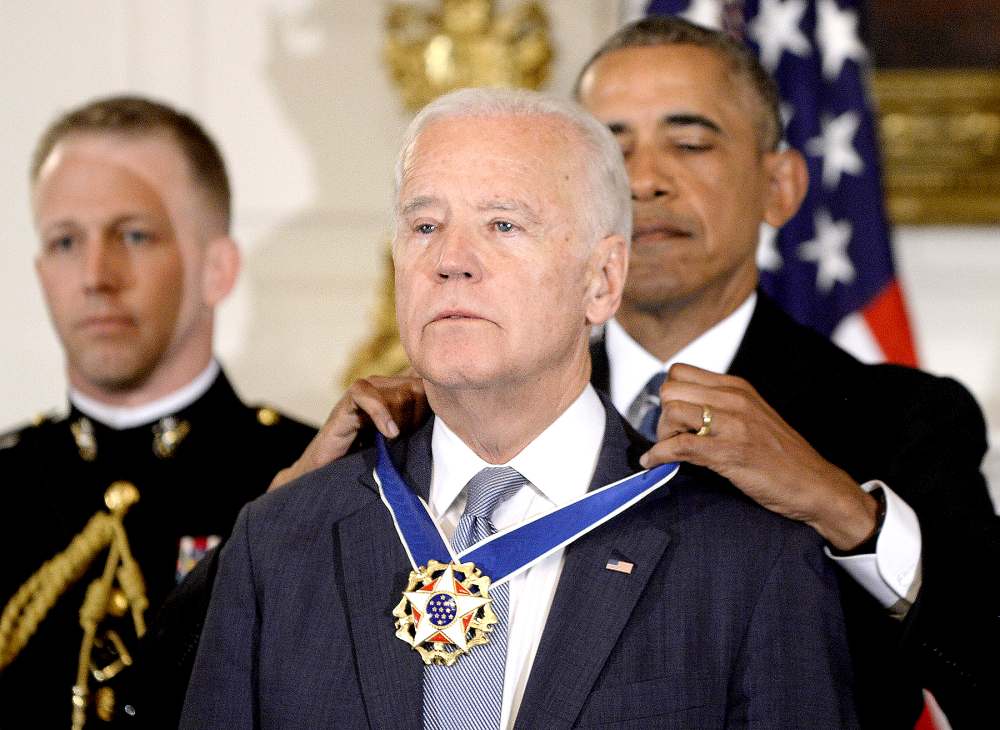 U.S. President Barack Obama (R) presents the Medal of Freedom to Vice-President Joe Biden during an event in the State Dinning room of the White House, January 12, 2017 in Washington, DC.