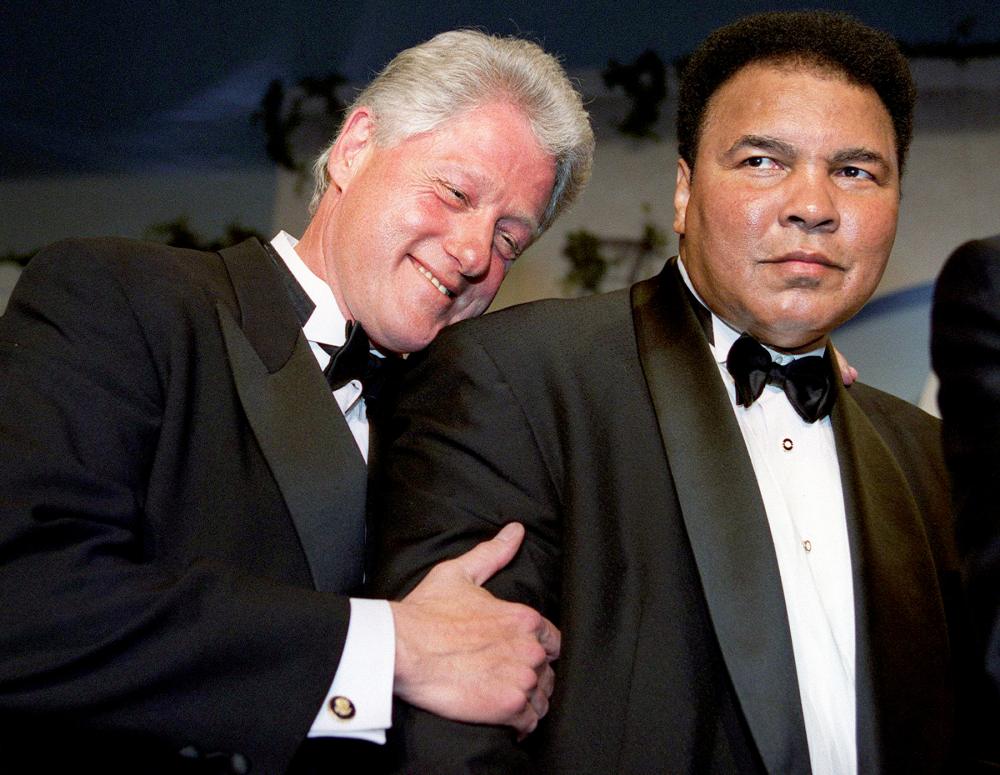 Bill Clinton leans on former world boxing heavyweight champion Muhammad Ali at the National Italian American Foundation 25th Anniversary Awards Gala Dinner at a Washington, D.C. hotel, Oct. 28, 2000.