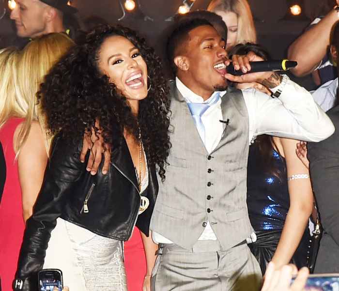 Brittany Bell and Nick Cannon perform onstage during the Maxim Party on January 31, 2015 in Phoenix, Arizona.