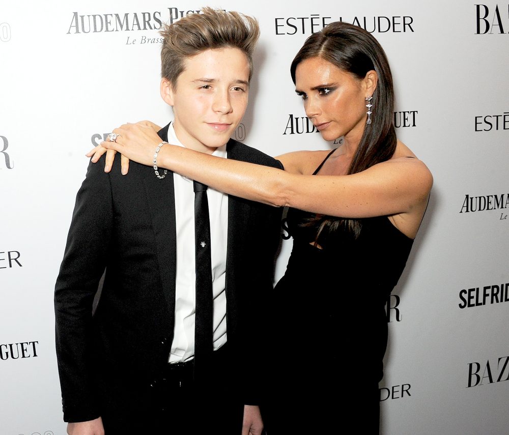 Brooklyn Beckham and Victoria Beckham arrive at the Harper's Bazaar Women of the Year awards at Claridge's Hotel on November 5, 2013 in London, England.