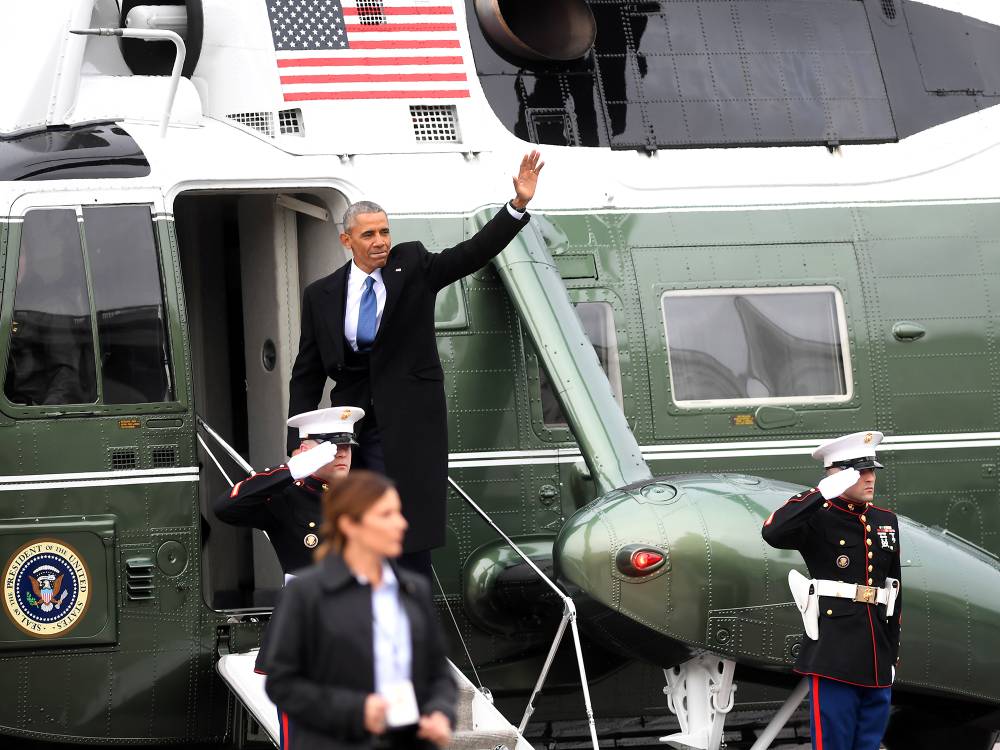 Former President Barack Obama waves as he boards a helicopter to depart the US Capitol after inauguration ceremonies for President Donald Trump at the US Capitol in Washington, DC, on January 20, 2017.