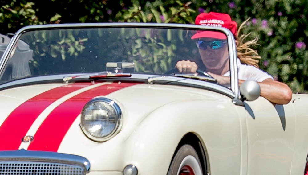 Caitlyn Jenner wears a red 'Make America Great Again' hat while cruising her classic car in Malibu on August 3, 2017.
