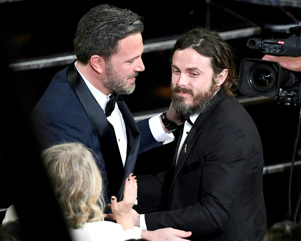 Winner for Best Actor "Manchester By The Sea" Casey Affleck (R) is embraced by his brother Ben Affleck on stage at the 89th Oscars on Feb. 26, 2017 in Hollywood, California.