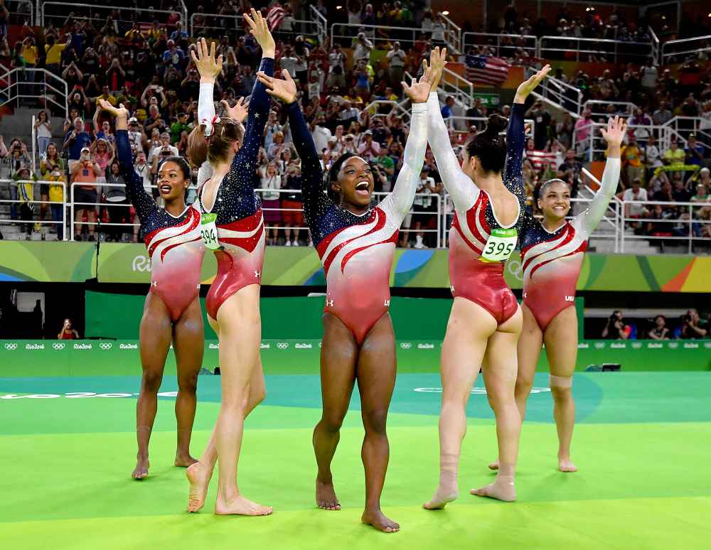 US gymnasts celebrate after the women's team final Artistic Gymnastics at the Olympic Arena during the Rio 2016 Olympic Games in Rio de Janeiro on August 9, 2016.