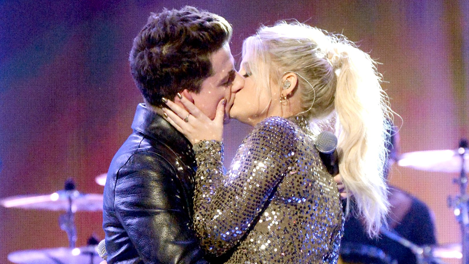 Charlie Puth and Meghan Trainor kiss onstage during the 2015 American Music Awards.
