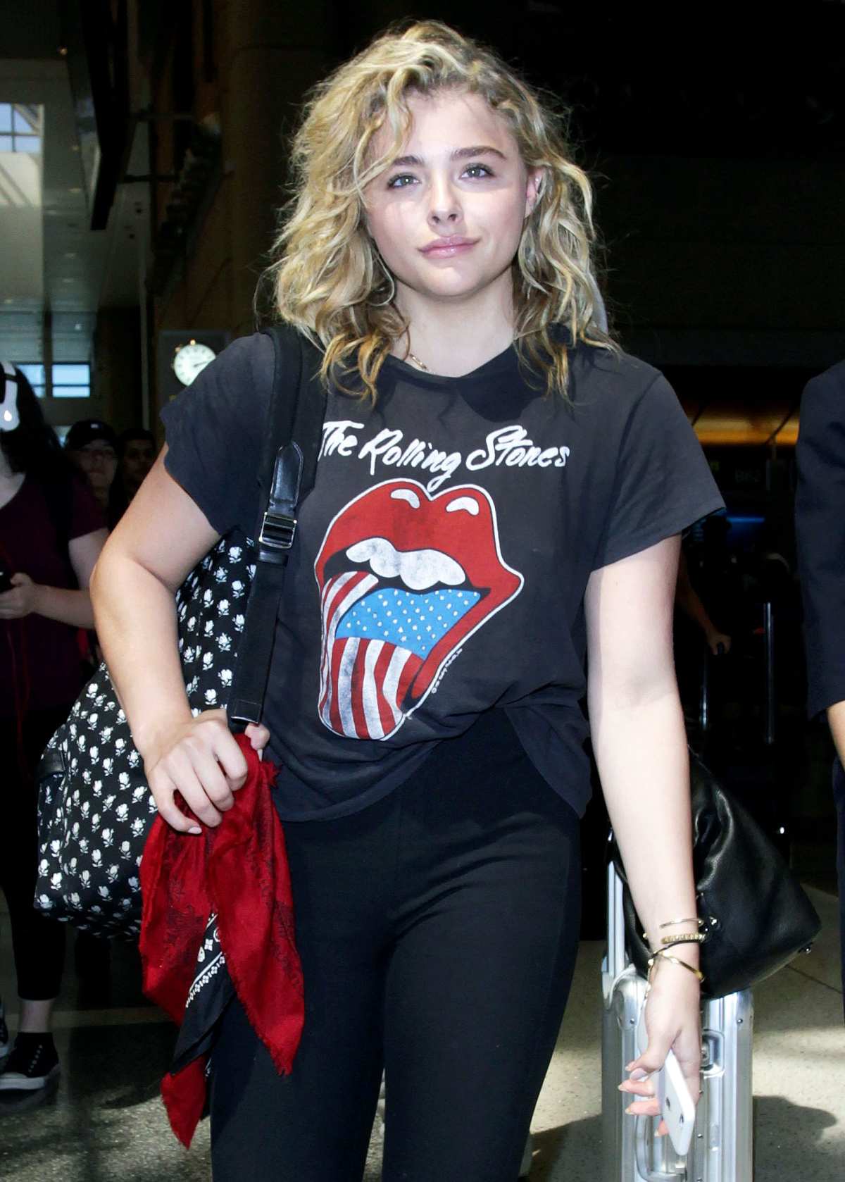 Chloe Grace Moretz wears a black trench coat and jeans while out