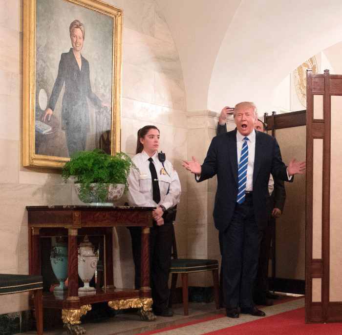 US President Donald Trump gestures as he surprises visitors during the official reopening of public tours at the White House in Washington, DC, March 7, 2017.